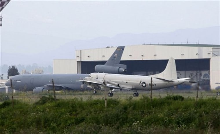 U.S. Air Force, background, and Navy, foreground, airplanes are seen Friday at Sigonella NATO military base, Sicily, Italy.